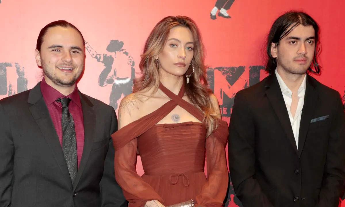 Michael Jackson’s children came together today in London, England, for a rare red carpet appearance at “MJ: The Musical.” Prince, 27, Paris, 25, and Bigi (formerly known as Blanket), 21, posed together at the opening, looking chic and formal. Their reunion comes amid Bigi’s legal battle with their grandma, Katherine Jackson.